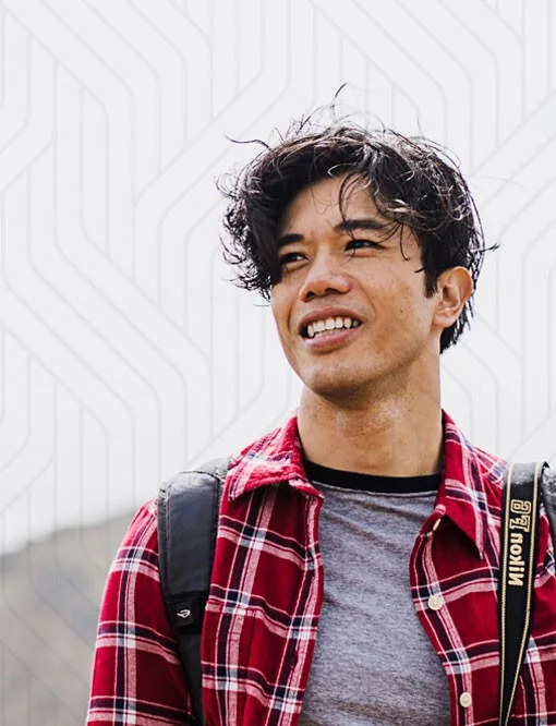 Young professional smiling outdoors