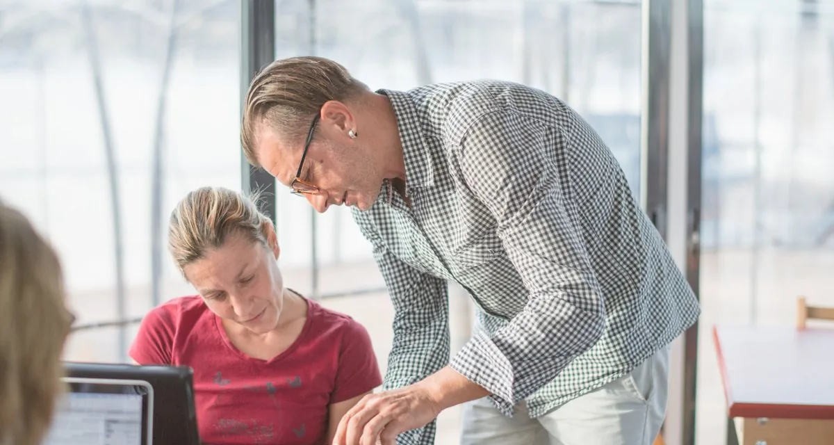 Consultant reviewing process documents with a colleague