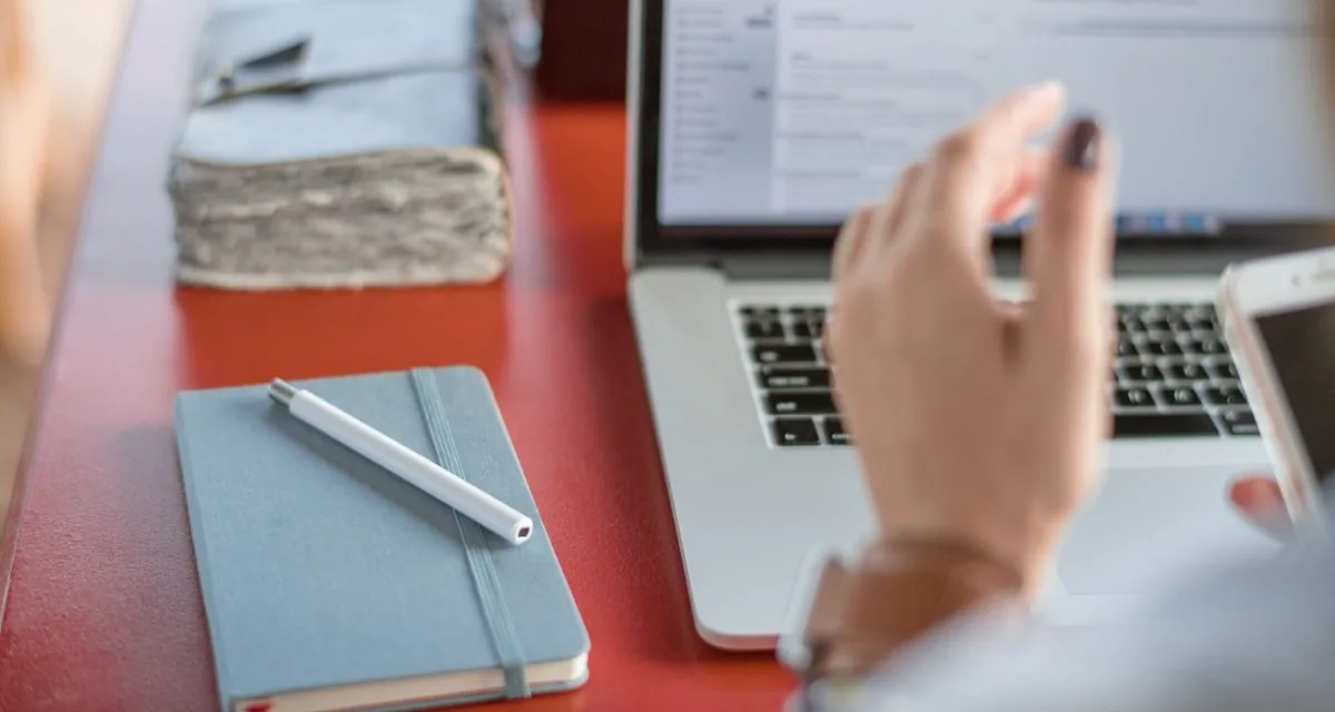 Laptop and notebook on a desk during a review session